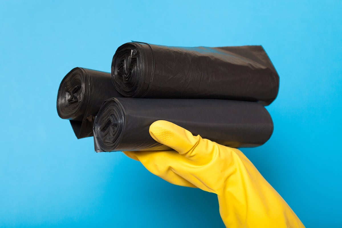 Clean black disposable trash bags, garbage clipping container